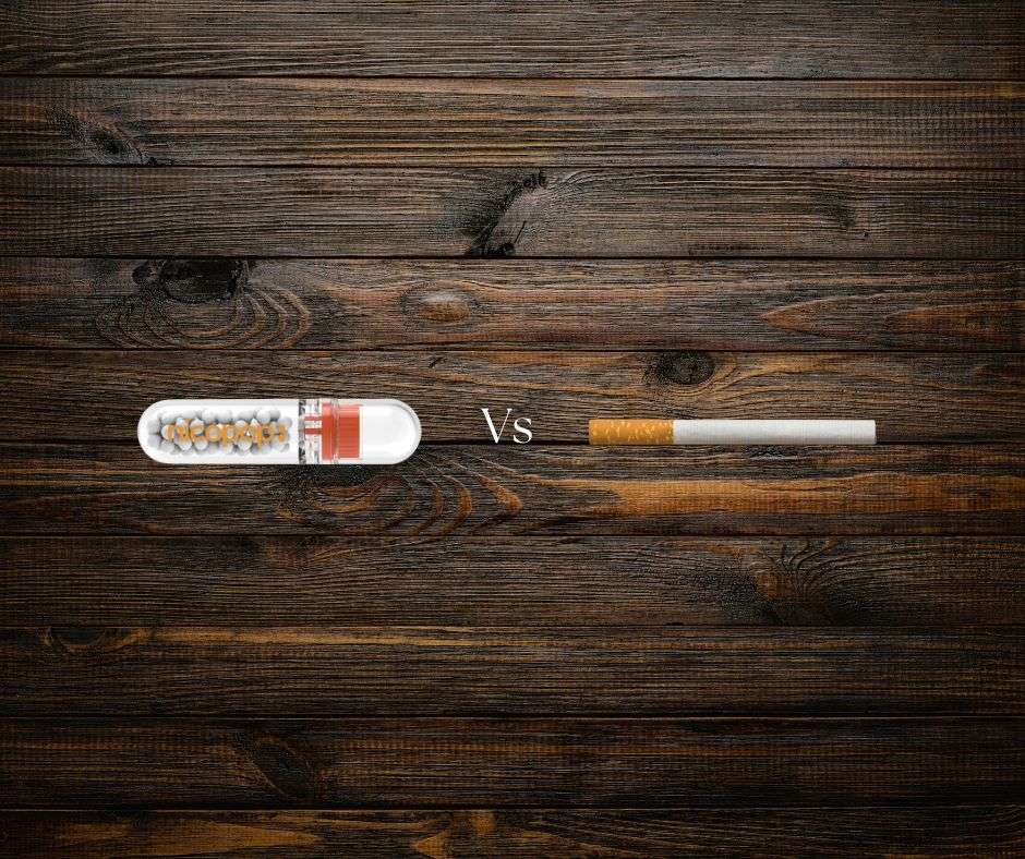 Nicopop tube and traditional cigarette on wooden background.
